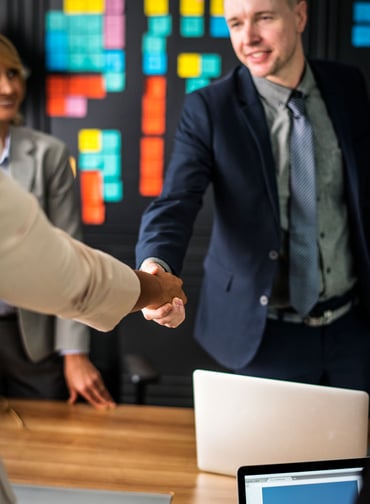 business-people-shaking-hands-meeting-room